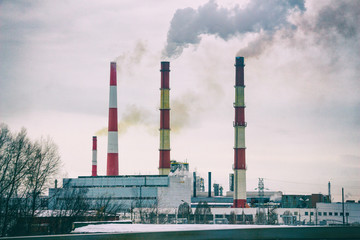 Smoking chimneys of the plant. Fuming chimney of a factory