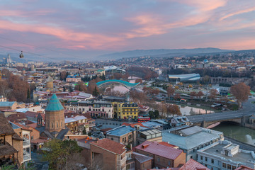 Fototapeta na wymiar TBILISI, GEORGIA - DEC.11, 2017 : The cityscape of Tbilisi view from the hill