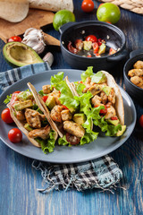 Authentic mexican tacos with chicken and salsa with avocado, tomatoes and chillies