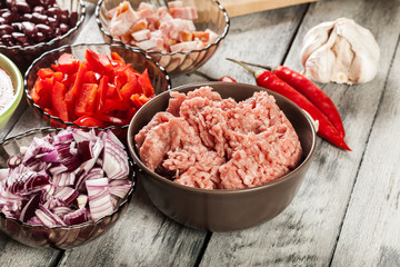 Ingredients ready for preparing chili con carne. Mincemeat, papr