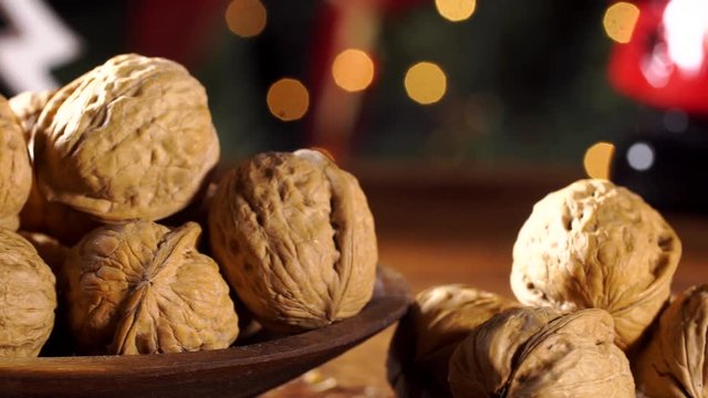 Walnut kernels on rustic old wooden table with christmas background. Slide shot. 