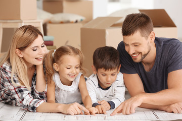 Happy family studying project of new flat
