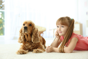 Cute little girl with dog at home