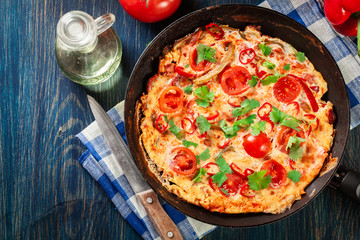 Frittata made of eggs, sausage chorizo, red pepper, green pepper