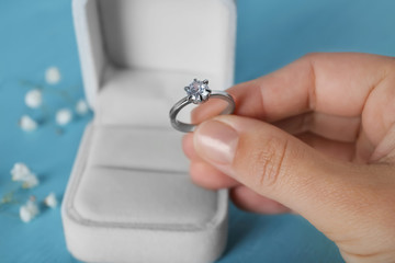 Woman holding luxury engagement ring, closeup