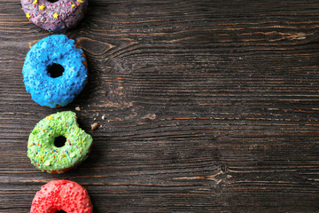 Tasty donuts on wooden table