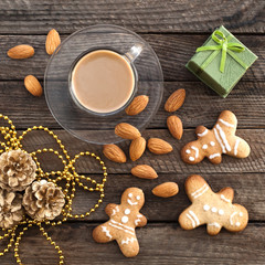 Christmas wooden background with a cup of coffee and biscuits