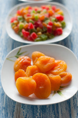 Candied dried apricots and pineapple cubes in plates