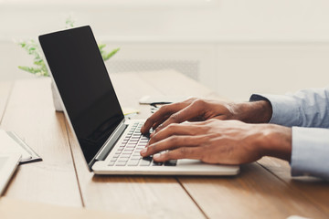 African-american businessman typing on laptop