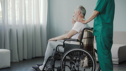 Old man residing on recovery at medical center after serious spine injury