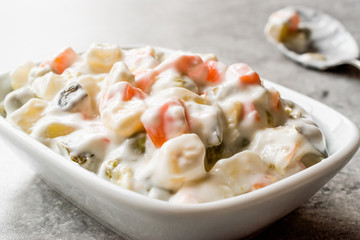 Russian Salad Olivier with beans, potatoes, carrot, yogurt and mayonnaise.
