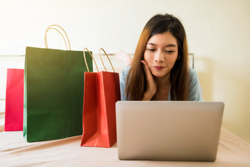 girl shopping online on bed