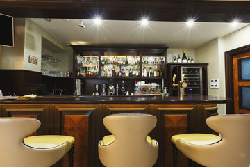 Hotel lounge bar with bottle shelfs and seats