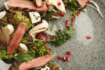 Warm mix salad with duck meat and mushrooms. Modern restaurant dish