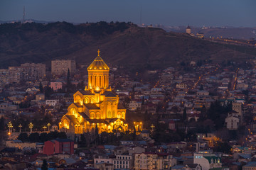 Fototapeta na wymiar TBILISI, GEORGIA - DEC.12, 2017 : Holy Trinity Cathedral of Tbilisi at dusk view from the hill