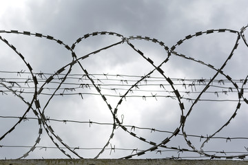 Barbed wire against the dark sky