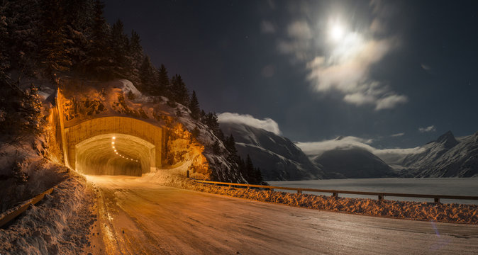 Fototapeta View of illuminated tunnel against sky during winter