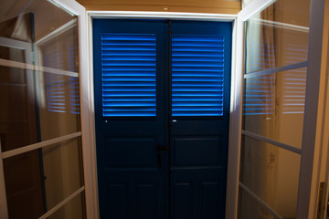 Blue door and window  with shutters