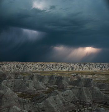 High angle majestic view of rock formations at Badlands National Park against stormy clouds