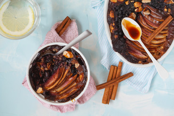 Vegan baked oatmeal crumble with apple, blueberry, Brazil nut and date syrup, top view