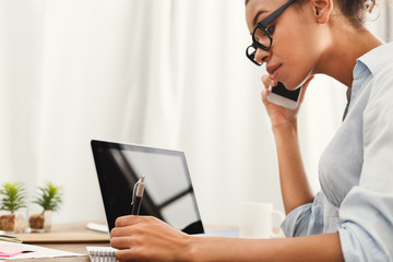 Young woman using laptop with blank screen