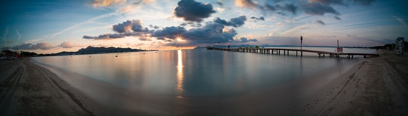 Obraz na płótnie Canvas Panorama of sunset or sunrise on the calm sea