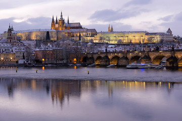 Christmas night snowy Prague Lesser Town with Charles Bridge and Prague Castle, Czech republic