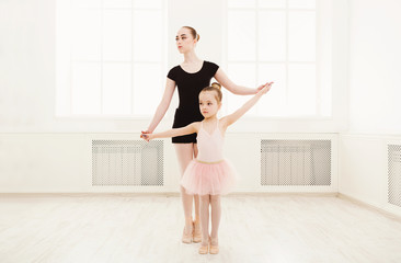 Little girl learn ballet with teacher copy space