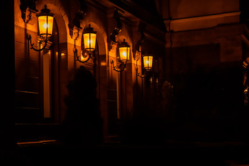 Fototapeta na wymiar Old lanterns on a wall of the house