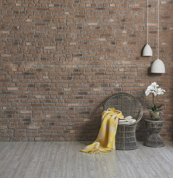 wicker armchair and natural wall paper with vase of flower