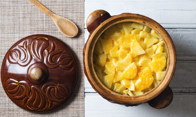 hot meat with potatoes in a pot top view
