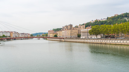 Fototapeta na wymiar Vieux-Lyon, colorful houses and footbridge in the center, on the river Saone 