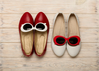 Women's shoes and sunglasses of red and white color.