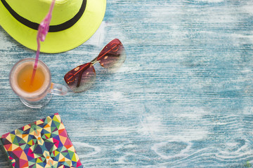 Vacation accessories on a blue wooden background