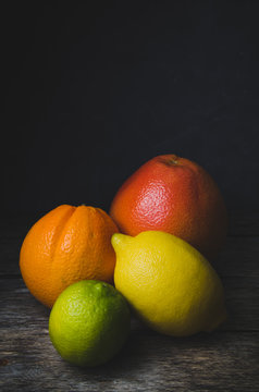 Tinted vertical photo of citrus fruits orange grapefruit lemon and lime