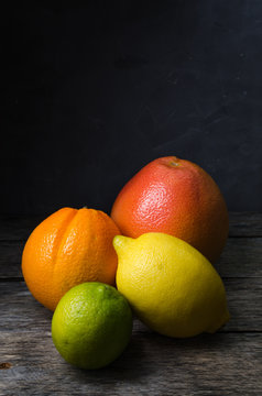 Vertical photo of citrus fruits orange grapefruit lemon and lime