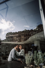 Obraz premium Two cheerful young loving people who drank coffee at coffee shops