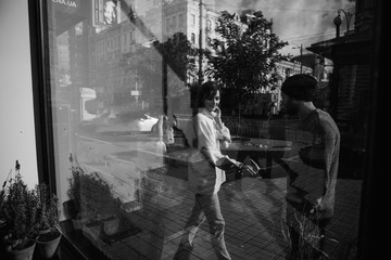 Beautiful couple in stylish clothes in gray tones, city