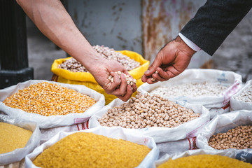  A client trying the stock in the food market. Dry seeds and fruits market in Turkey