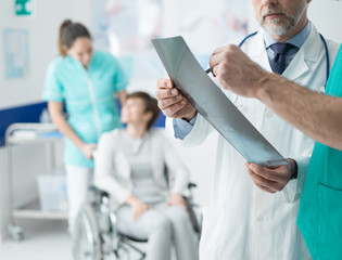 Fototapeta premium Professional doctors examining patient's x-ray