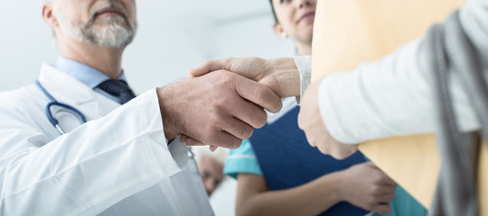 Doctor and patient giving an handshake