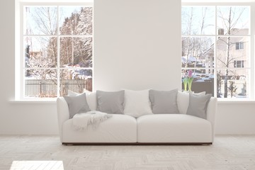 Fototapeta premium White room with sofa and winter landscape in window. Scandinavian interior design. 3D illustration