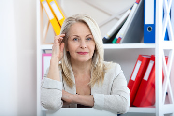 Modern businesswoman. Beautiful middle aged woman looking at camera
