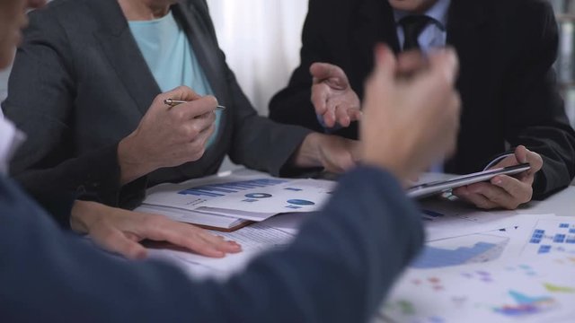 Campaign office workers looking at exit poll results, elections development plan
