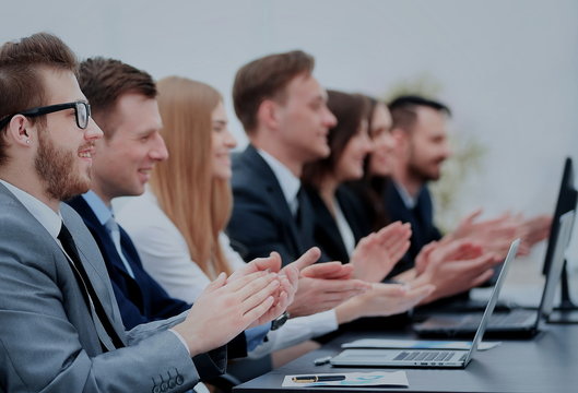 Photo of happy business people applauding at conference