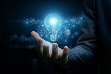 Drawing a light bulb in hand businessman.