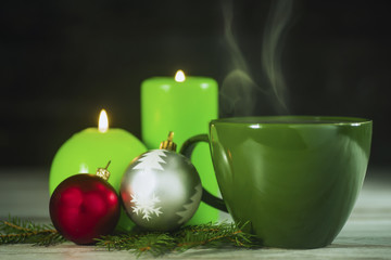 Obraz na płótnie Canvas Christmas concept, hot tea and green candles
