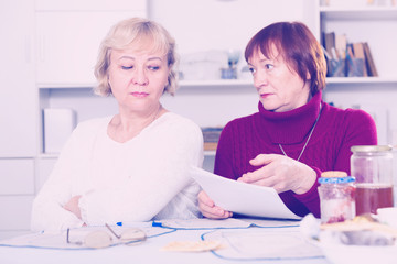 Obraz premium Serious old women with public utilities