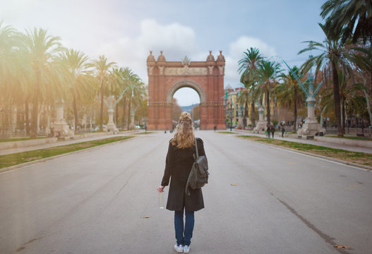 back view of blonde woman with Arc de Triomf in Barcelona in background