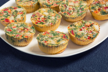 Egg muffins with onion , pepper , bacon